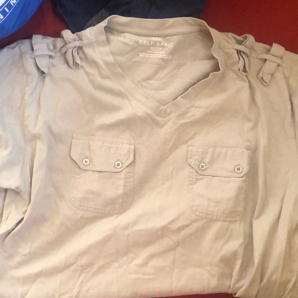 Tan t-shirt with button front pockets.